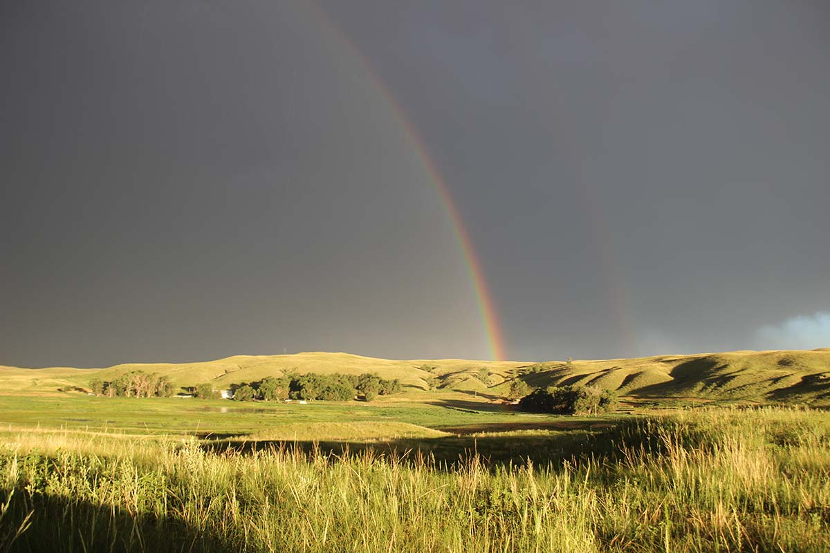A rainbow over the valley in July